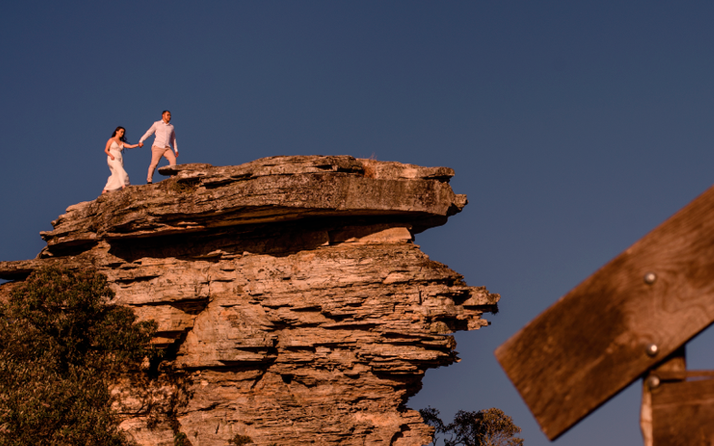 Dupla no topo da pedra ao entardecer